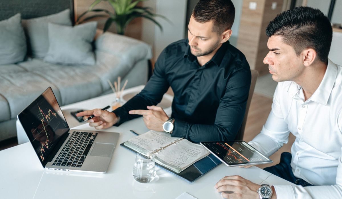Healthcare compliance consultant and client reviewing vendor contract terms during a negotiation